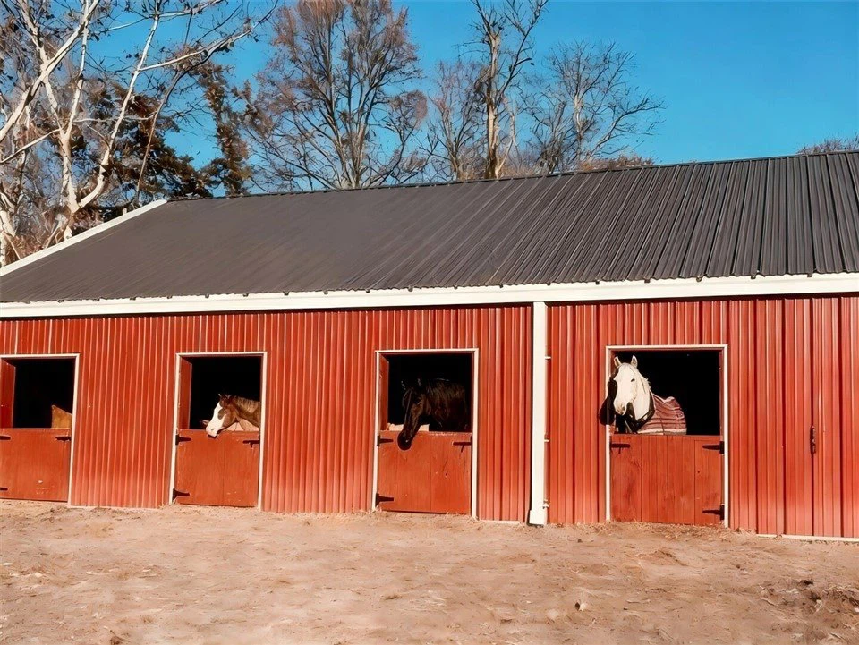 red-steel-equestrian-stable-with-horses